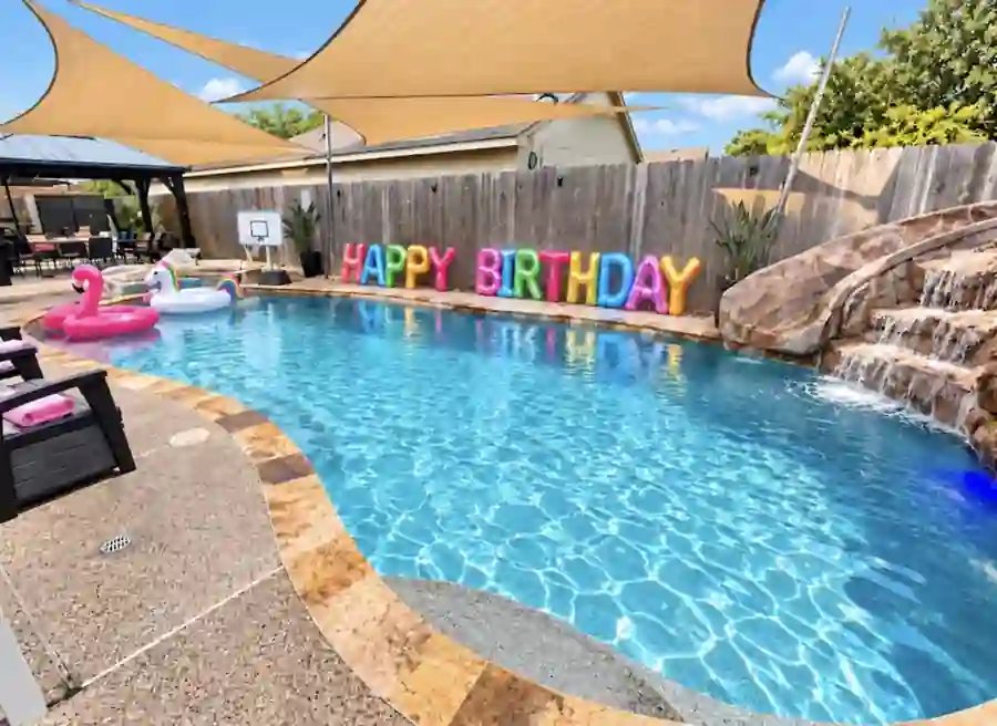 Private pool birthday setup with HAPPY BIRTHDAY letters at Cypress River Oasis